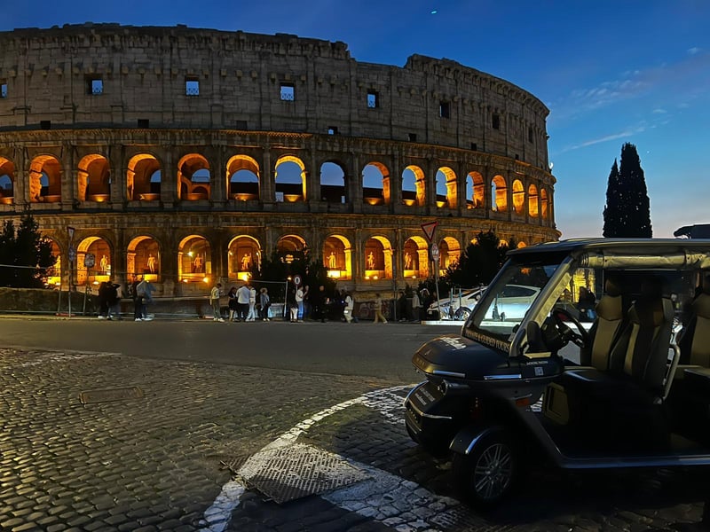 Private golf cart tour passing the illuminated Colosseum in Rome at night Private golf cart tour passing the illuminated Colosseum in Rome at night