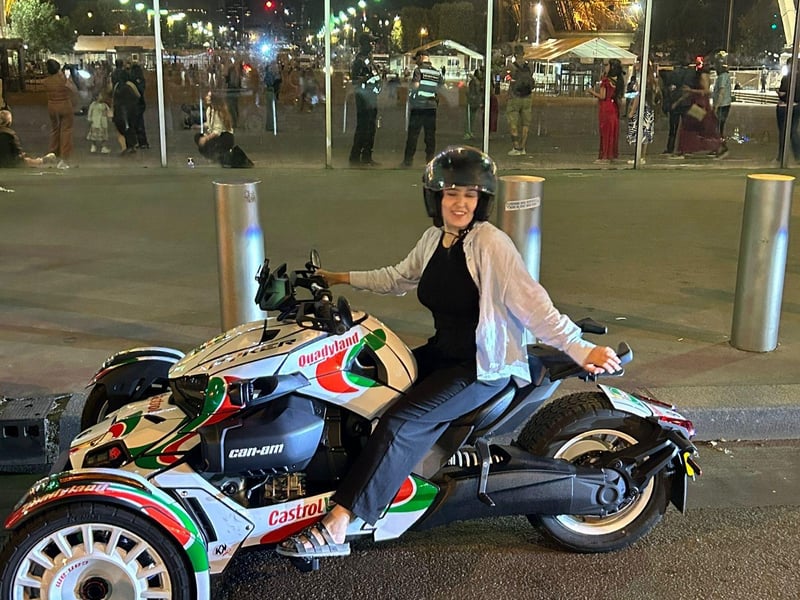 Thrilling night ride on a Can-Am through Paris with the illuminated Eiffel Tower in the background Thrilling night ride on a Can-Am through Paris with the illuminated Eiffel Tower in the background
