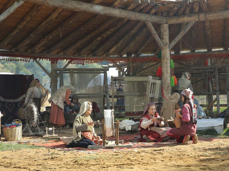 Visitors wearing traditional Ottoman costumes at the Ertugrul and Osman Ghazi movie set tour in Istanbul, smiling and posing on a historic film set. Visitors wearing traditional Ottoman costumes at the Ertugrul and Osman Ghazi movie set tour in Istanbul, smiling and posing on a historic film set.
