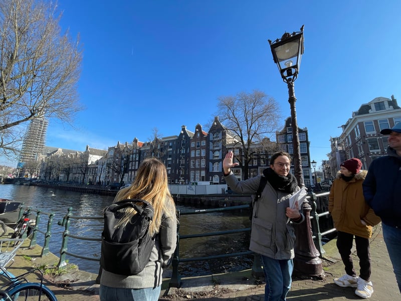 Amsterdam pop culture tour group experiencing Anne Frank House VR by the historic canals at dusk Amsterdam pop culture tour group experiencing Anne Frank House VR by the historic canals at dusk