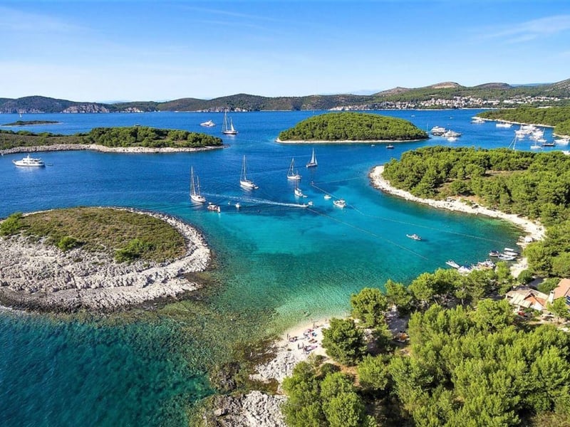 Aerial view of a private speedboat in the stunning turquoise waters of Hvar's Pakleni Islands, Croatia Aerial view of a private speedboat in the stunning turquoise waters of Hvar's Pakleni Islands, Croatia
