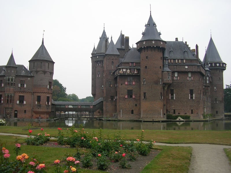 De Haar Castle, the largest castle in the Netherlands, reflected in its scenic moat surrounded by gardens. De Haar Castle, the largest castle in the Netherlands, reflected in its scenic moat surrounded by gardens.