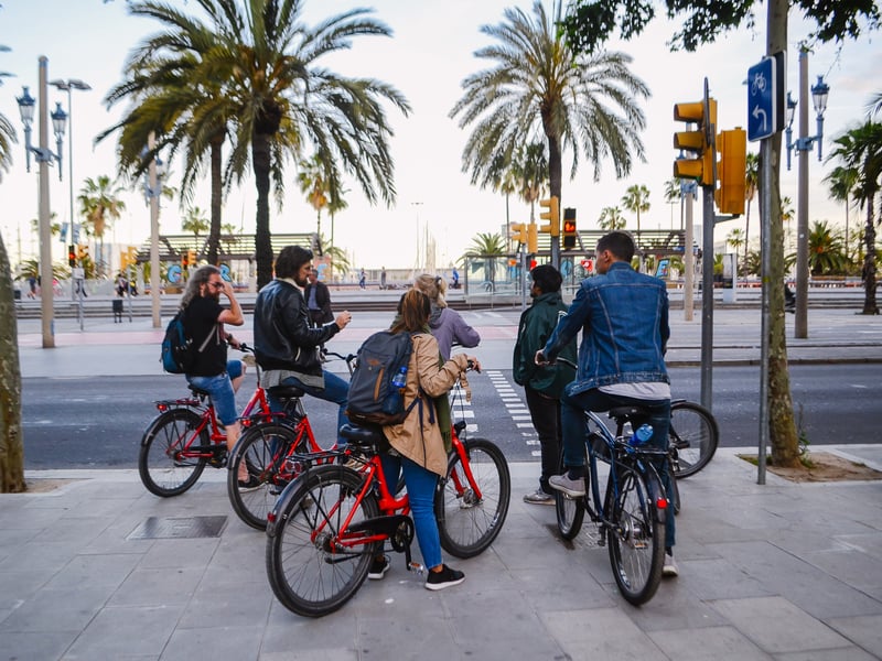 A guided night tour group exploring the illuminated, narrow medieval streets of Barcelona's Gothic Quarter. A guided night tour group exploring the illuminated, narrow medieval streets of Barcelona's Gothic Quarter.