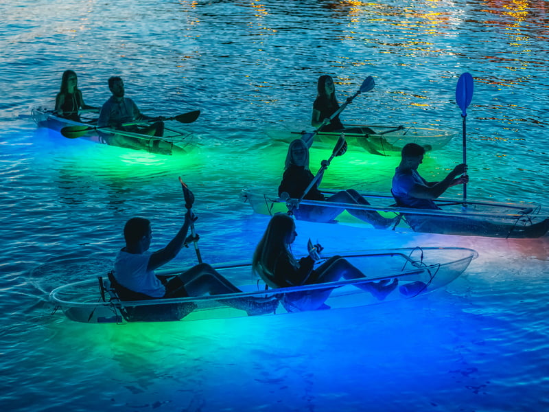 Couple kayaking at sunset on the calm Adriatic Sea near Split, Croatia with Marjan Park in the background. Couple kayaking at sunset on the calm Adriatic Sea near Split, Croatia with Marjan Park in the background.
