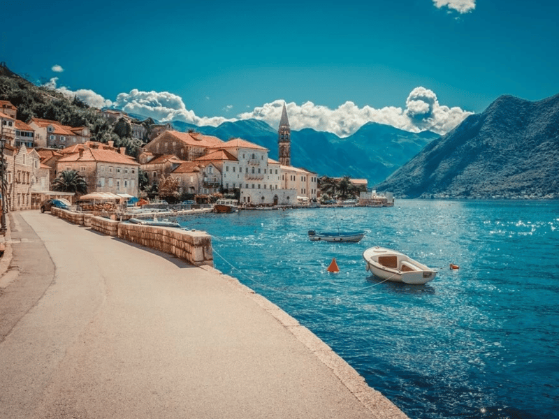 Panoramic golden hour view of Sveti Stefan island, Montenegro, with terracotta roofs and turquoise sea Panoramic golden hour view of Sveti Stefan island, Montenegro, with terracotta roofs and turquoise sea