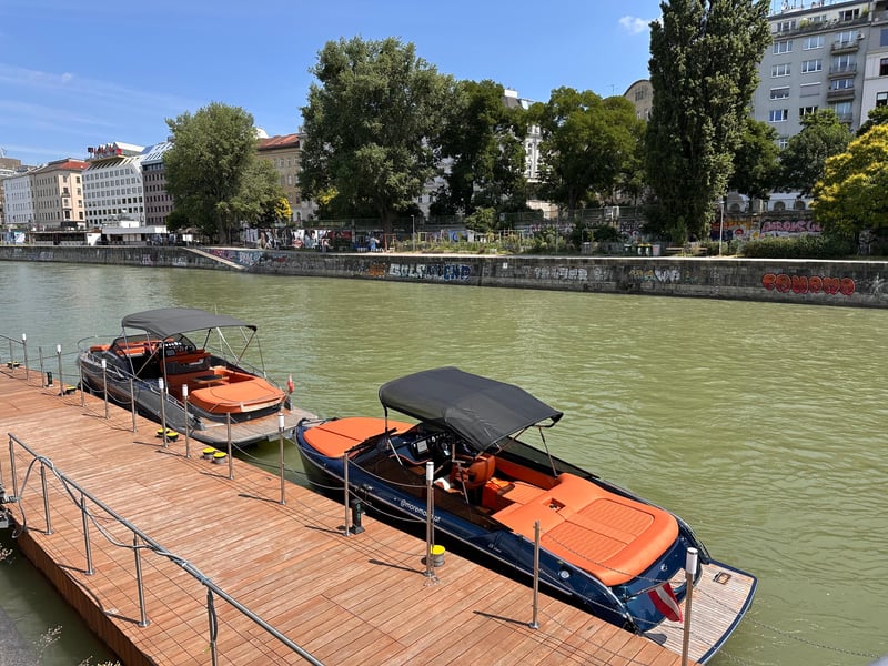 Evening luxury yacht party on the Danube in Vienna with guests and illuminated city skyline. Evening luxury yacht party on the Danube in Vienna with guests and illuminated city skyline.