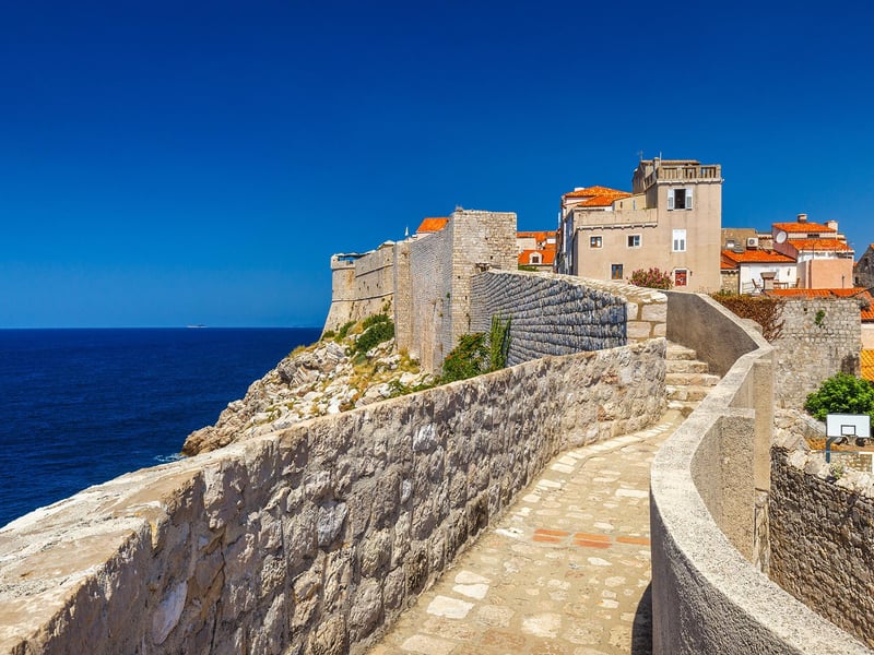 Visitors enjoying fast-track access on Dubrovnik's historic City Walls with panoramic views of the Old Town and sea. Visitors enjoying fast-track access on Dubrovnik's historic City Walls with panoramic views of the Old Town and sea.