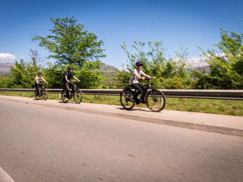 Group on e-bikes touring vineyards and heading towards a waterfall in Podgorica, Montenegro. Group on e-bikes touring vineyards and heading towards a waterfall in Podgorica, Montenegro.