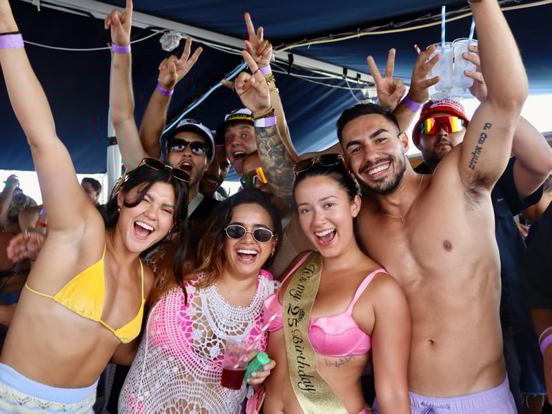 Lively boat party in Split, Croatia at sunset with a dancing crowd, DJ, and historic palace skyline. Lively boat party in Split, Croatia at sunset with a dancing crowd, DJ, and historic palace skyline.