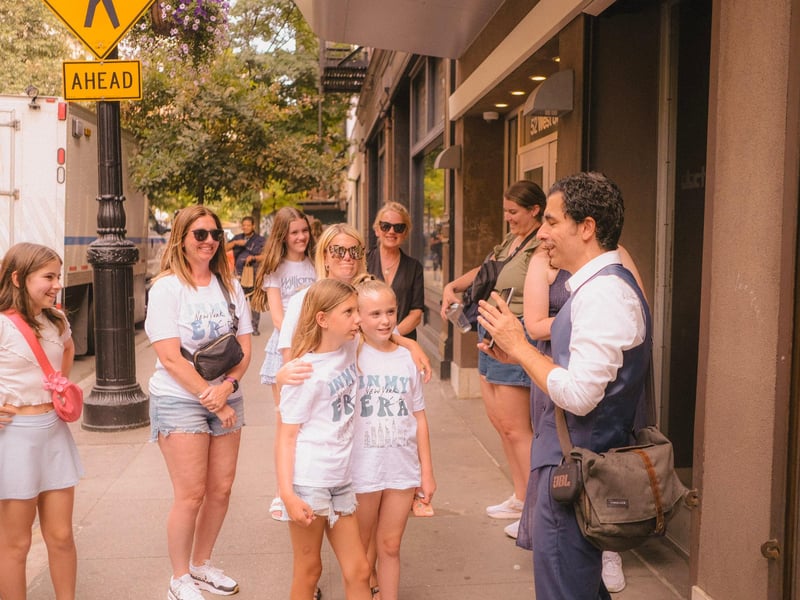 A friendly guided walking tour group exploring the historic streets and vibrant street art of Greenwich Village in New York City. A friendly guided walking tour group exploring the historic streets and vibrant street art of Greenwich Village in New York City.
