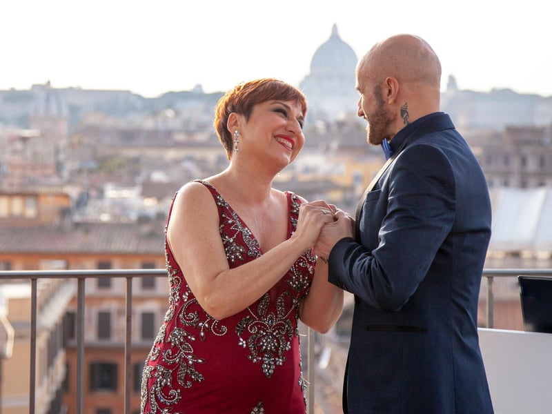 Elegant rooftop bar in Rome at sunset with guests enjoying drinks and panoramic views of the Eternal City. Elegant rooftop bar in Rome at sunset with guests enjoying drinks and panoramic views of the Eternal City.