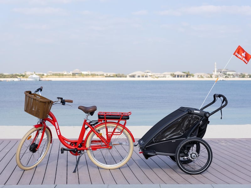 Happy family on a scenic bike ride along Dubai Water Canal with Burj Khalifa reflected in water Happy family on a scenic bike ride along Dubai Water Canal with Burj Khalifa reflected in water