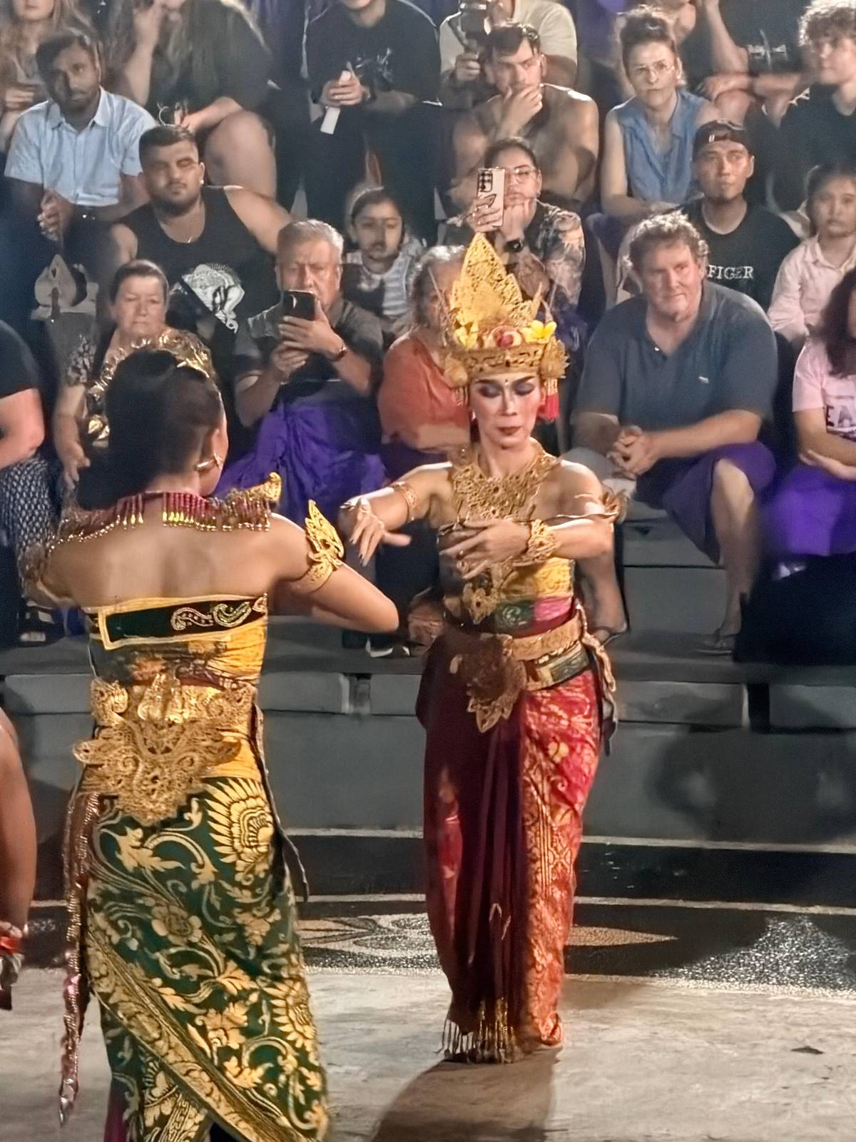 Shinta in gold and green on the stage floor