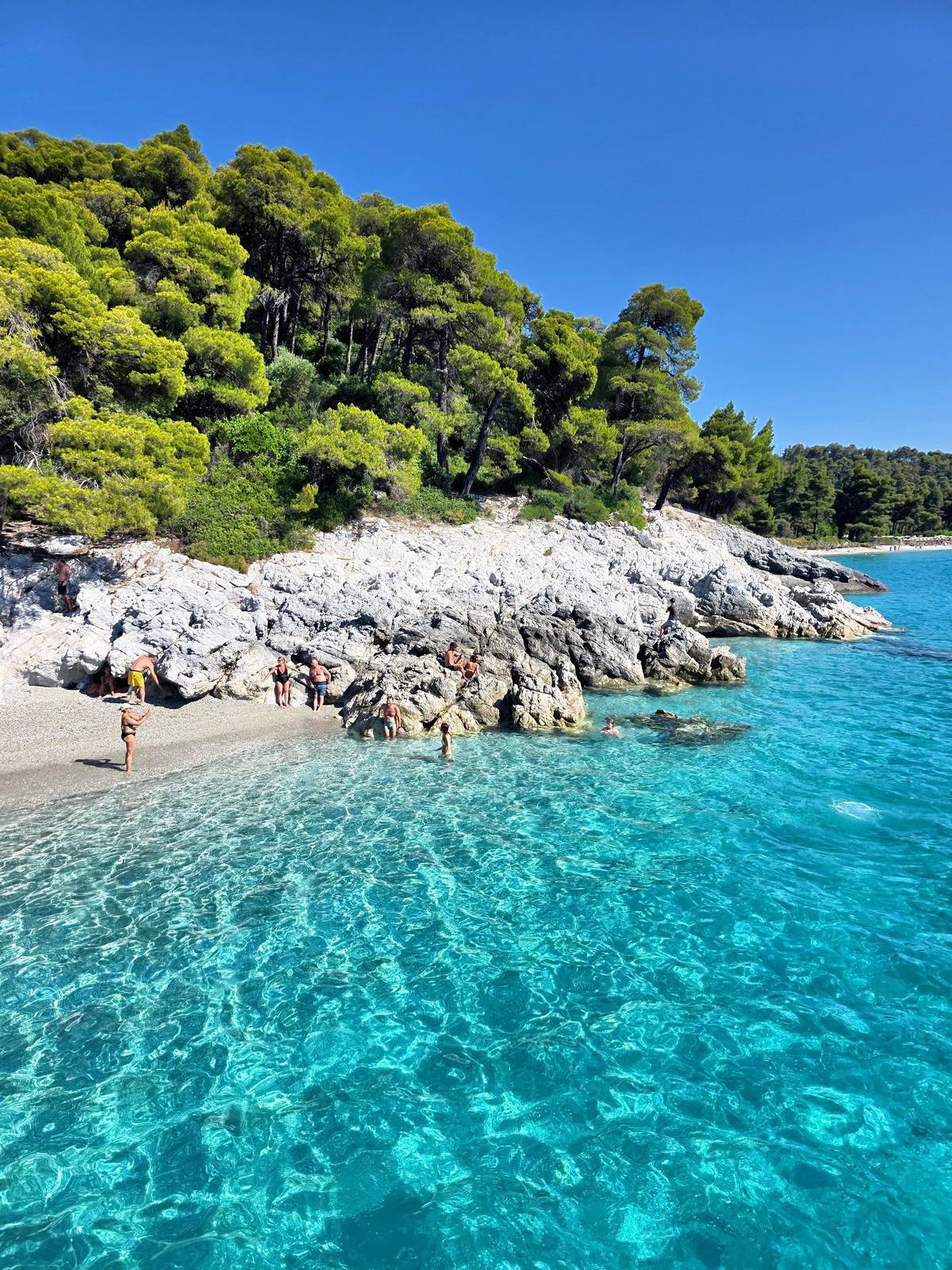 Turquoise water off a pebble cove