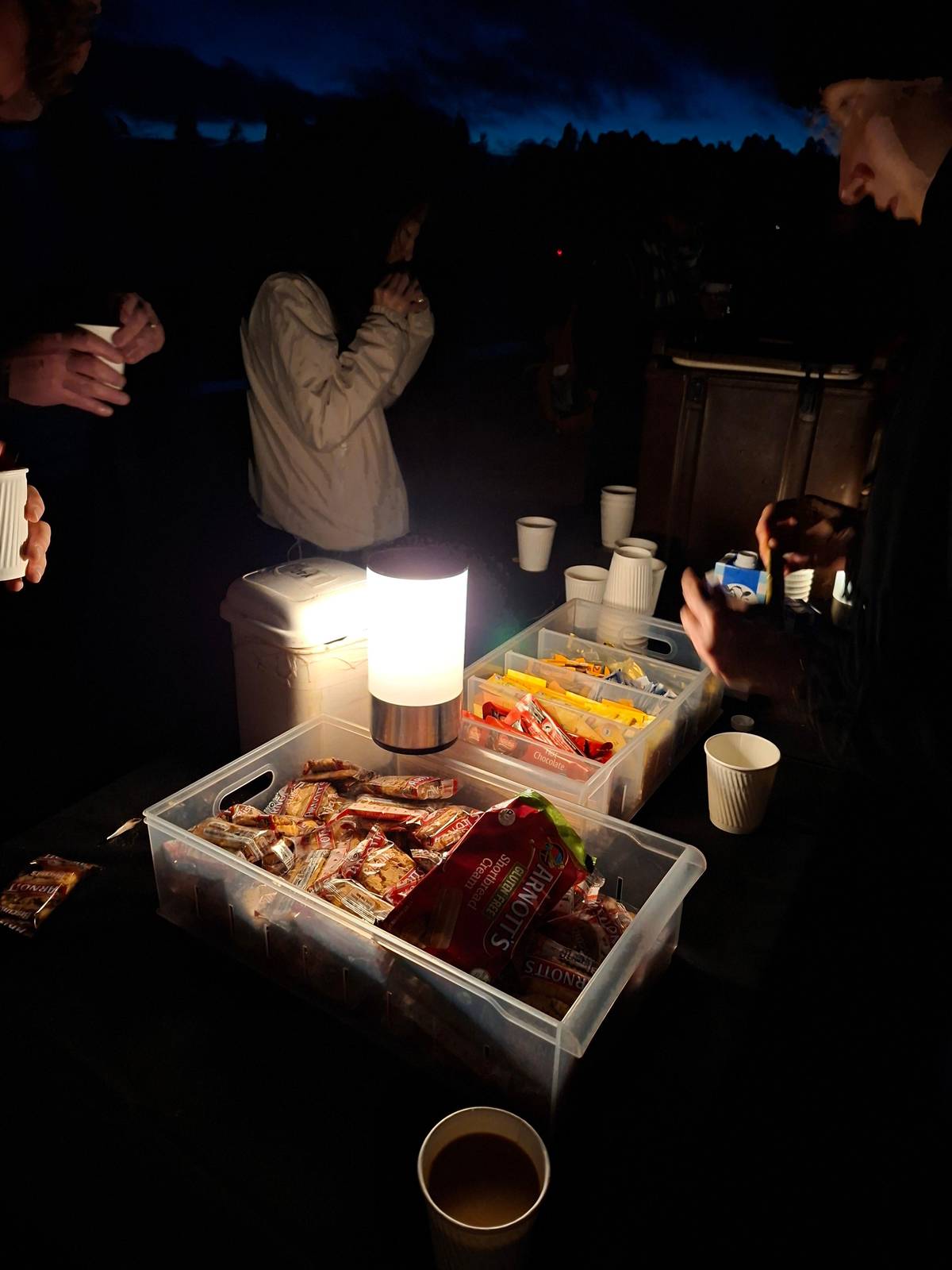 Tea, coffee and biscuits set out in the dark before sunrise