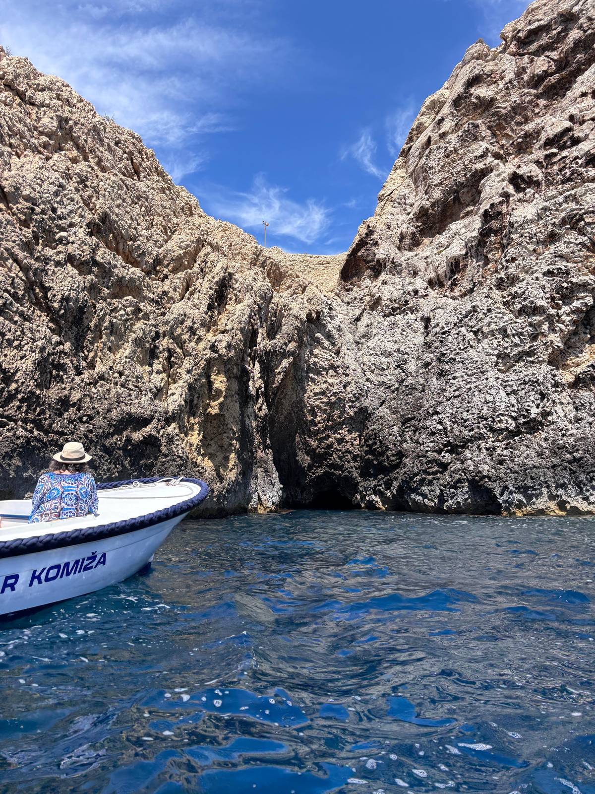 A small boat at the mouth of Stiniva cove