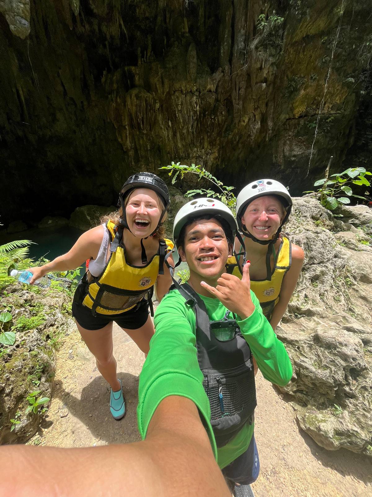 Canyoneers in helmets on the river trail