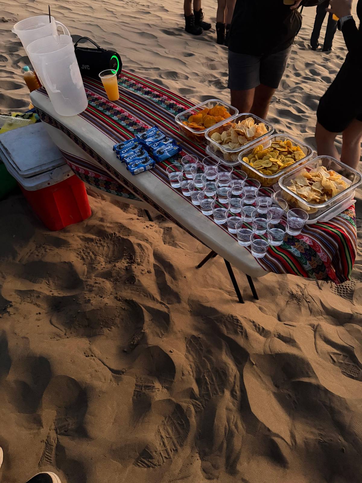 Snacks and cups set out on a table in the desert