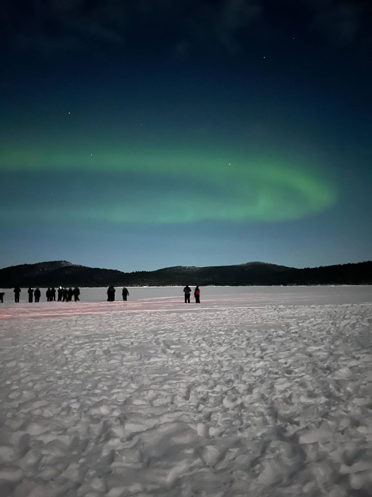A group on a frozen lake under the lights