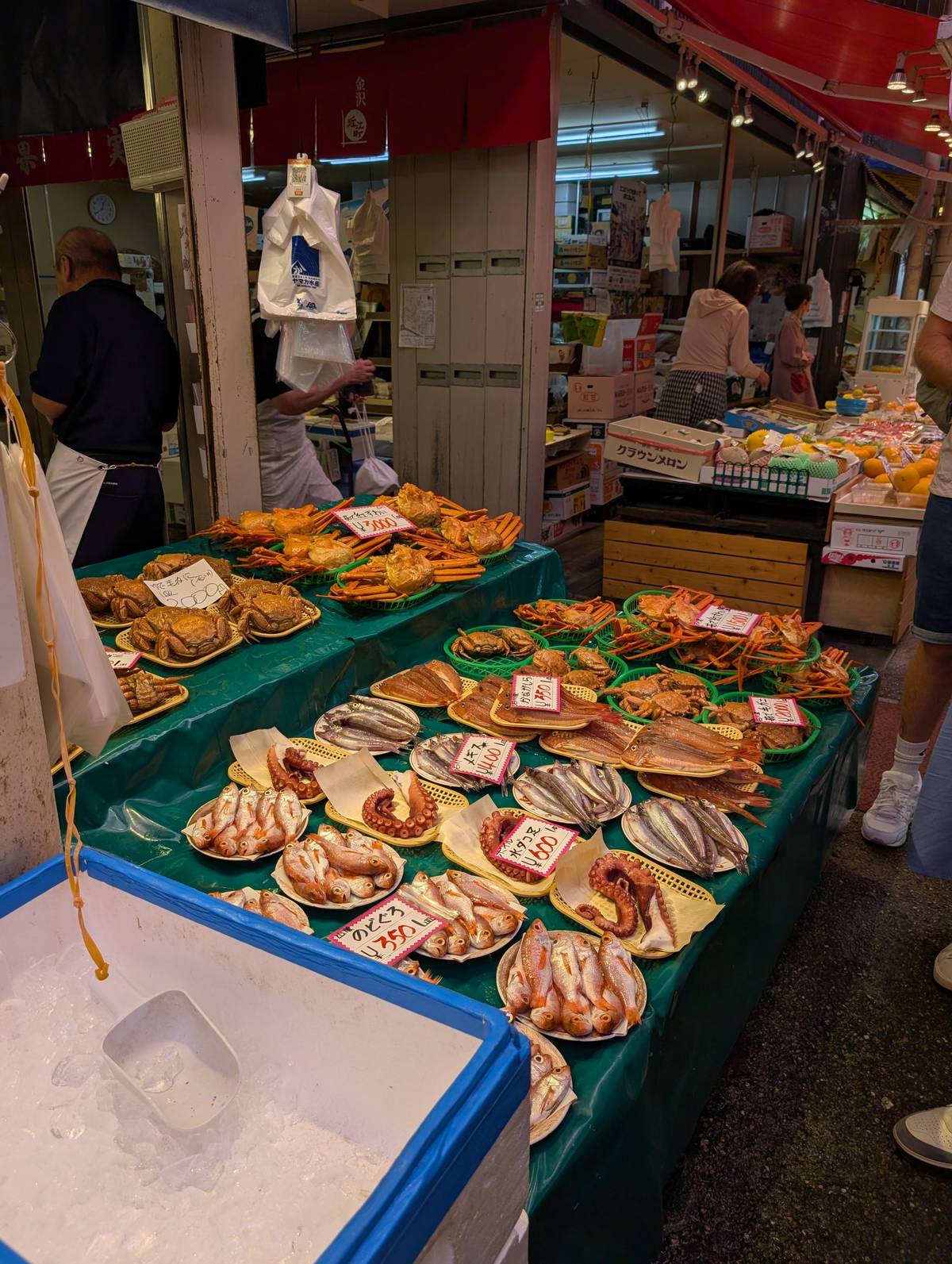 Trays of crab and dried fish at a market stall