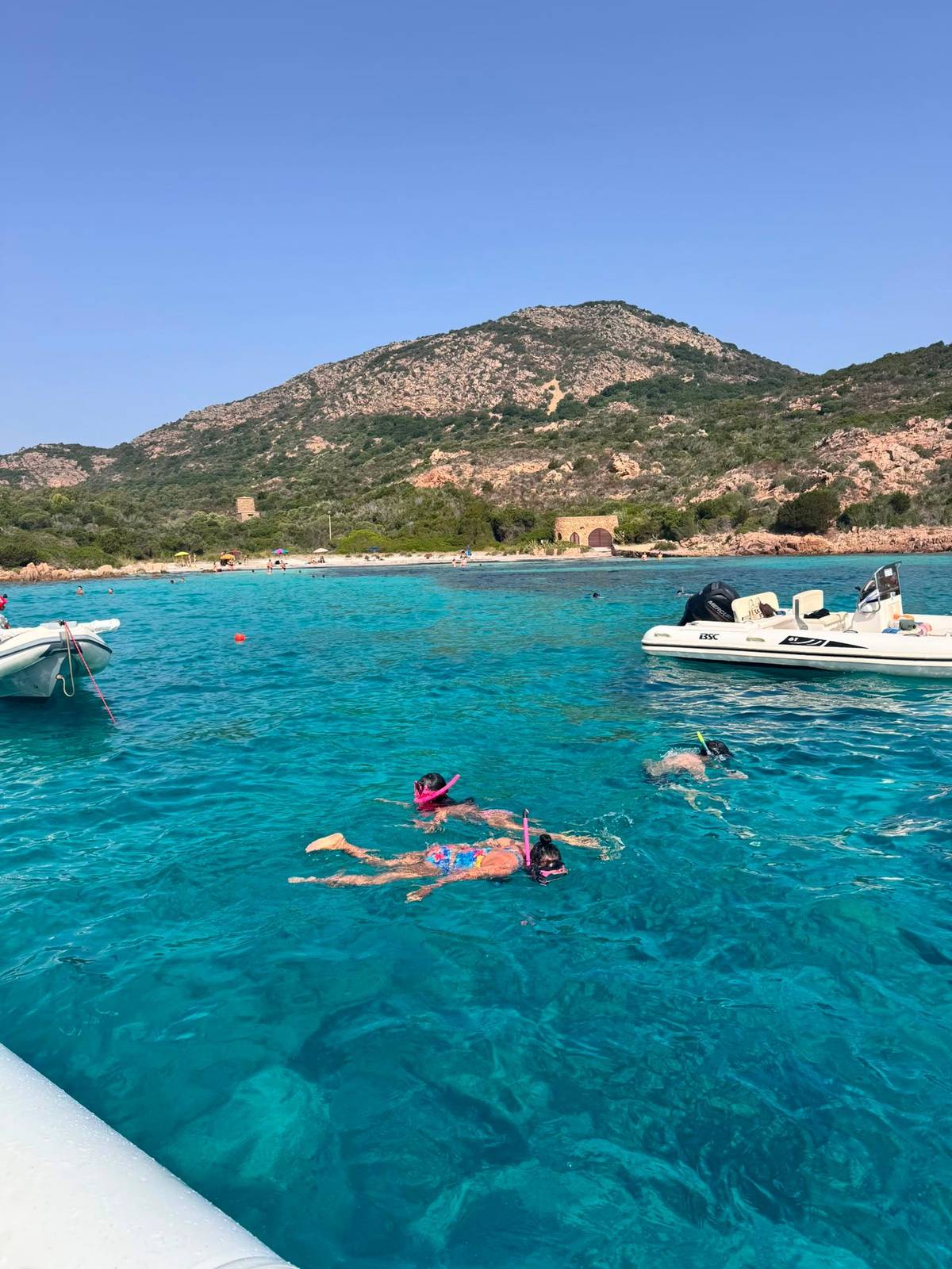 Snorkelers in the turquoise shallows