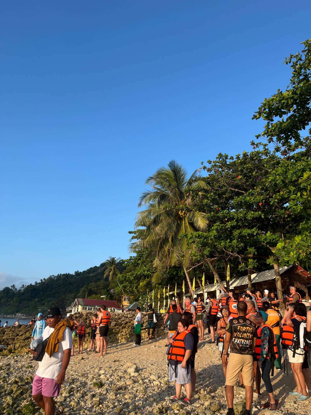 Swimmers in life jackets waiting at dawn