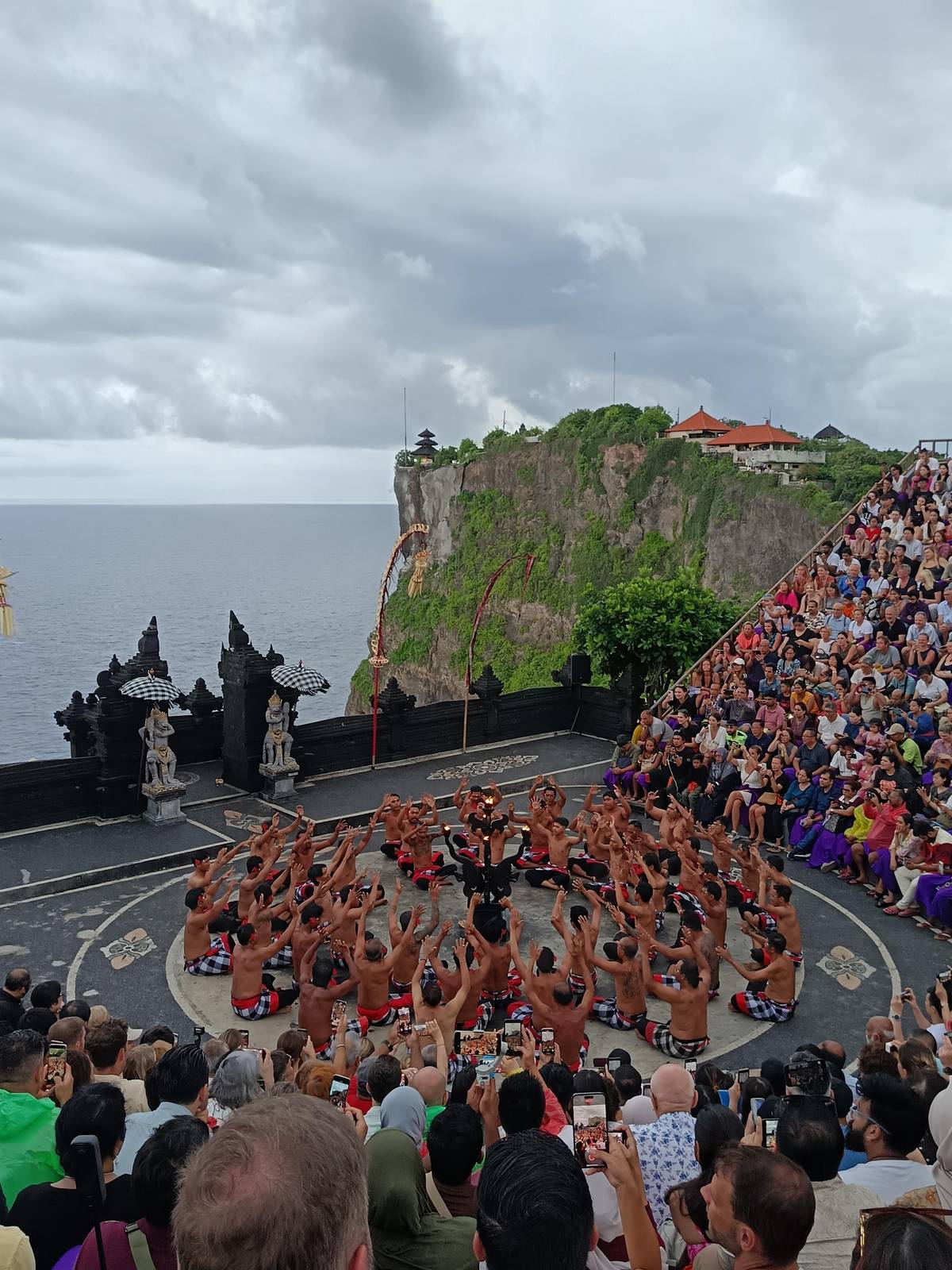 The circle of men below the cliff and the temple
