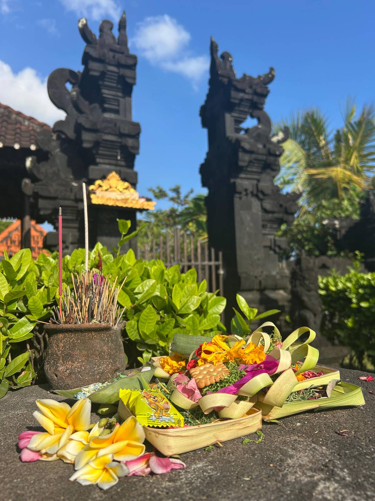 A palm-leaf offering at a split temple gate