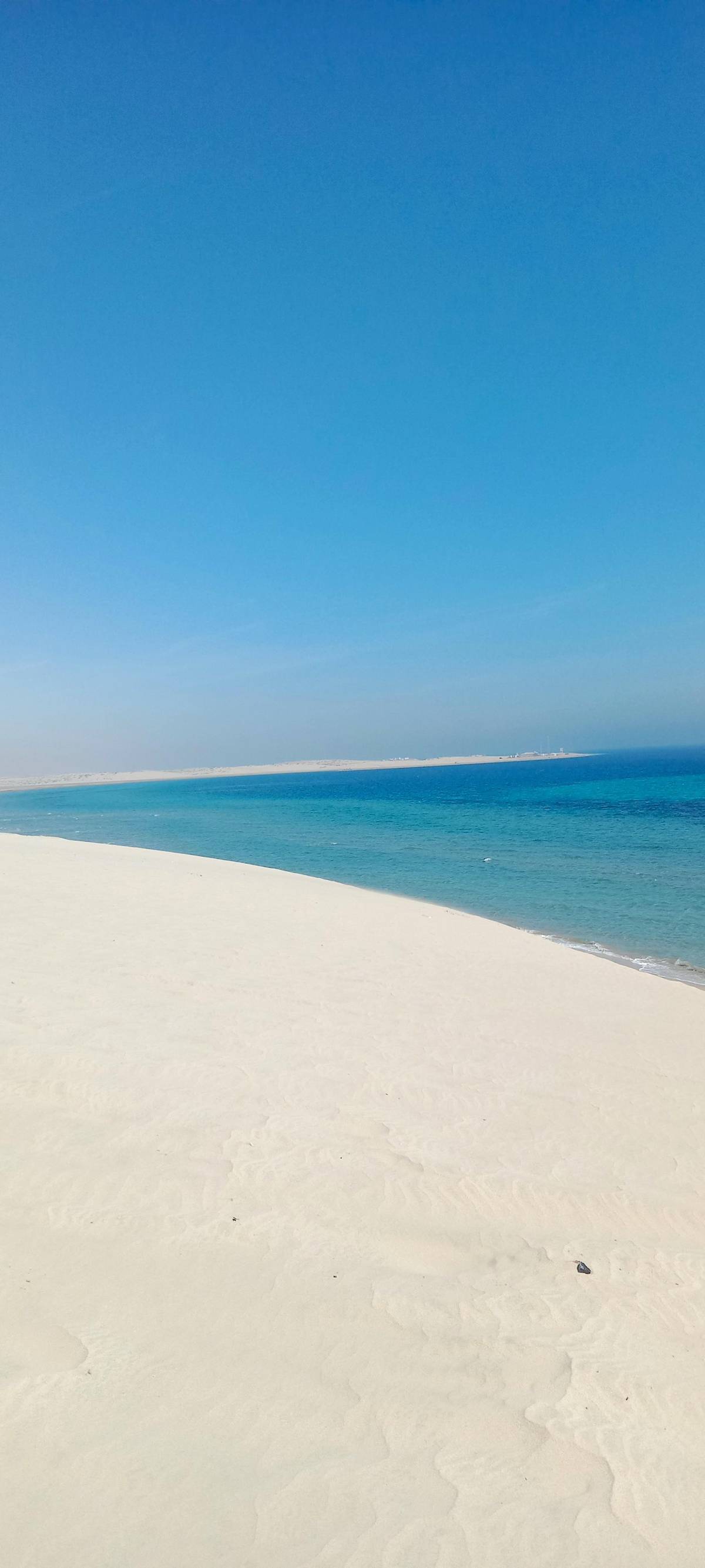 Turquoise water lapping a white sand beach