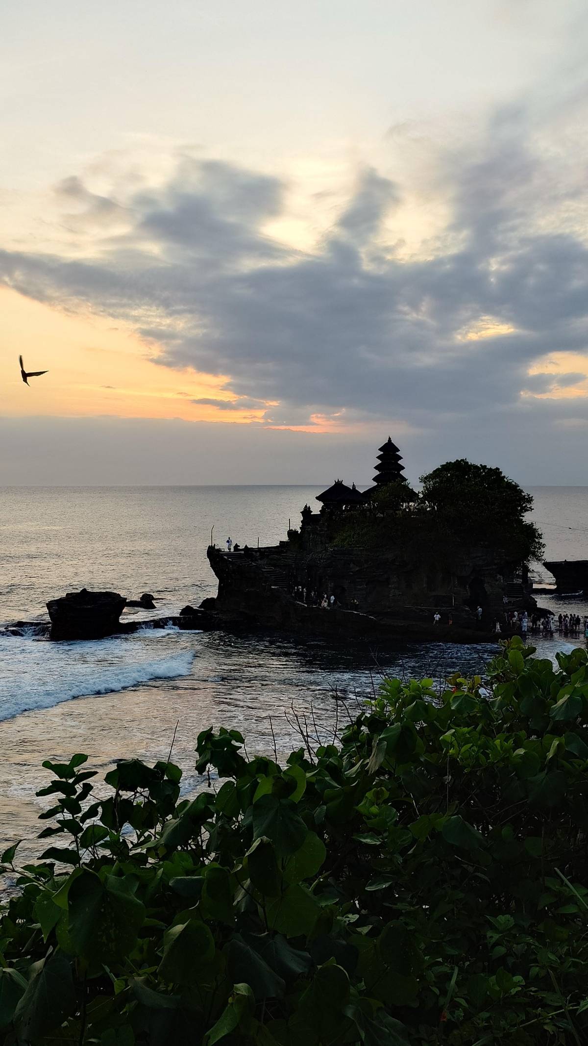 Tanah Lot as a dark outline in the evening light
