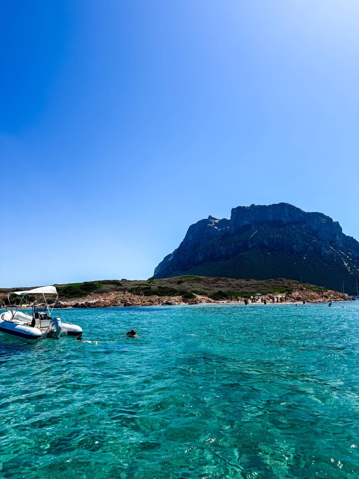 Tavolara behind a cove of pink granite