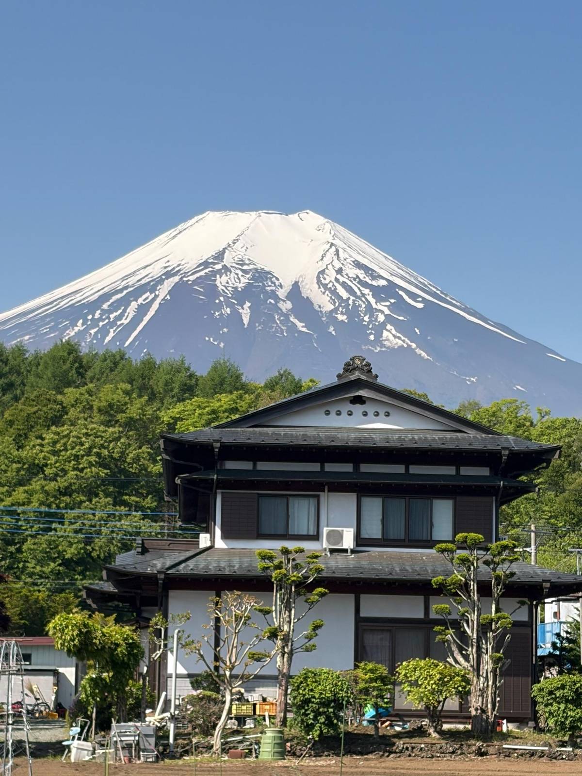 A traditional house below the snowy peak