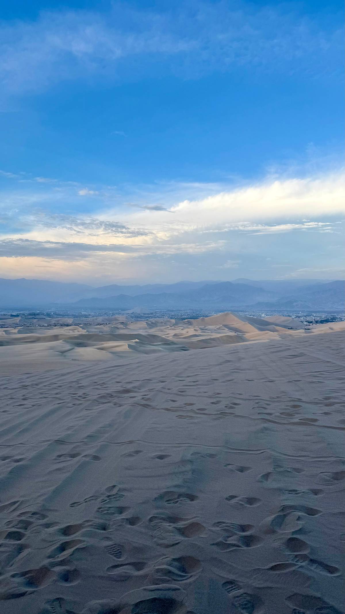 Dunes falling away towards the valley at dusk