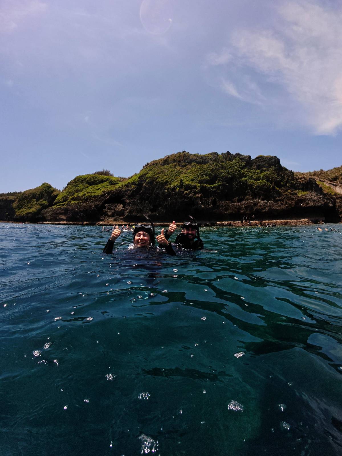 Snorkelers below the cliffs of the cape