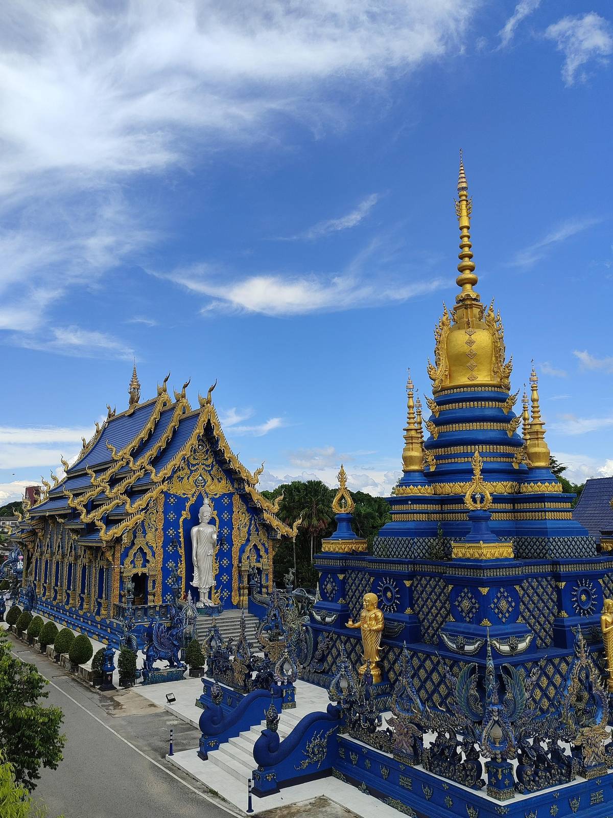 The Blue Temple hall beside its blue and gold chedi