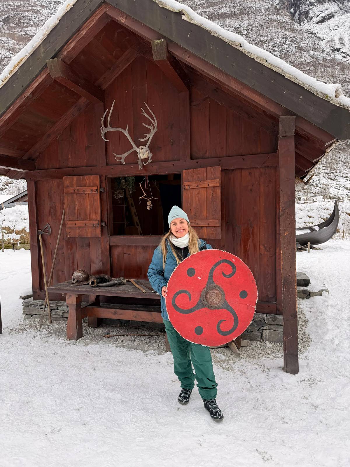 A guest with a Viking shield in the snowy village