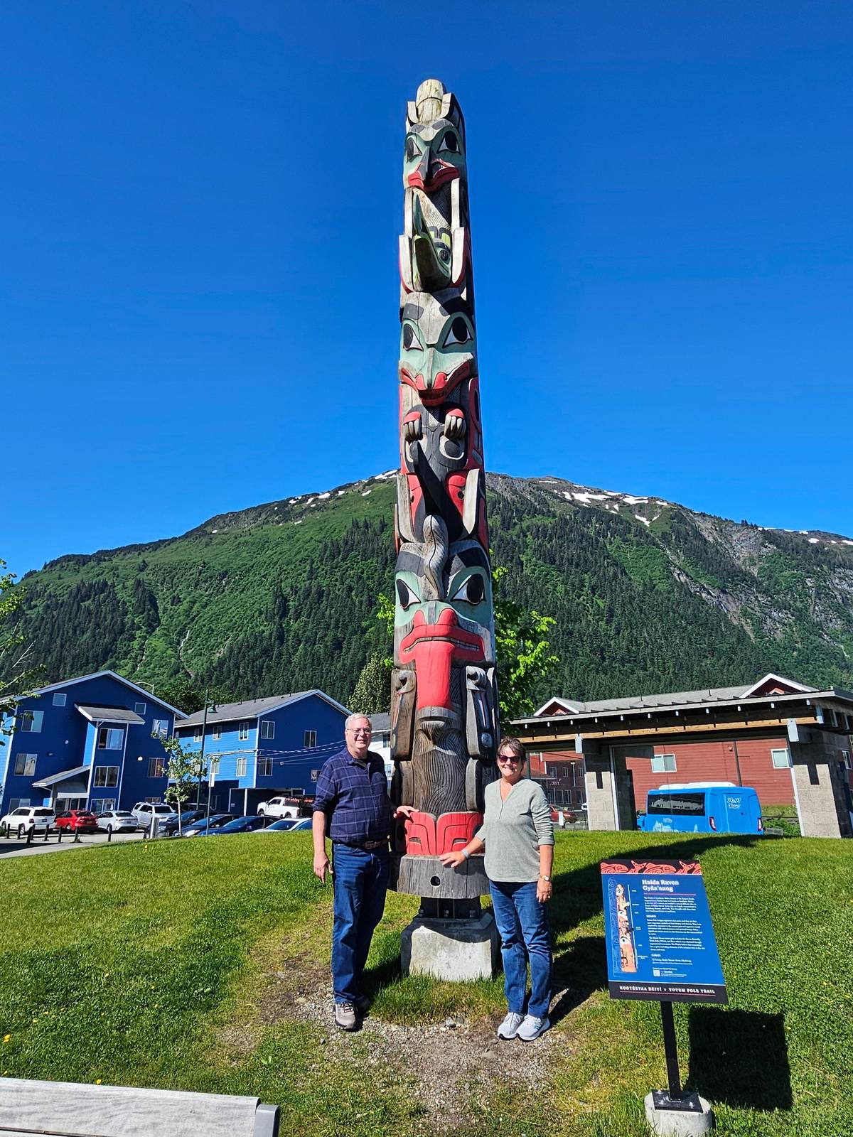 A carved totem pole beside the road