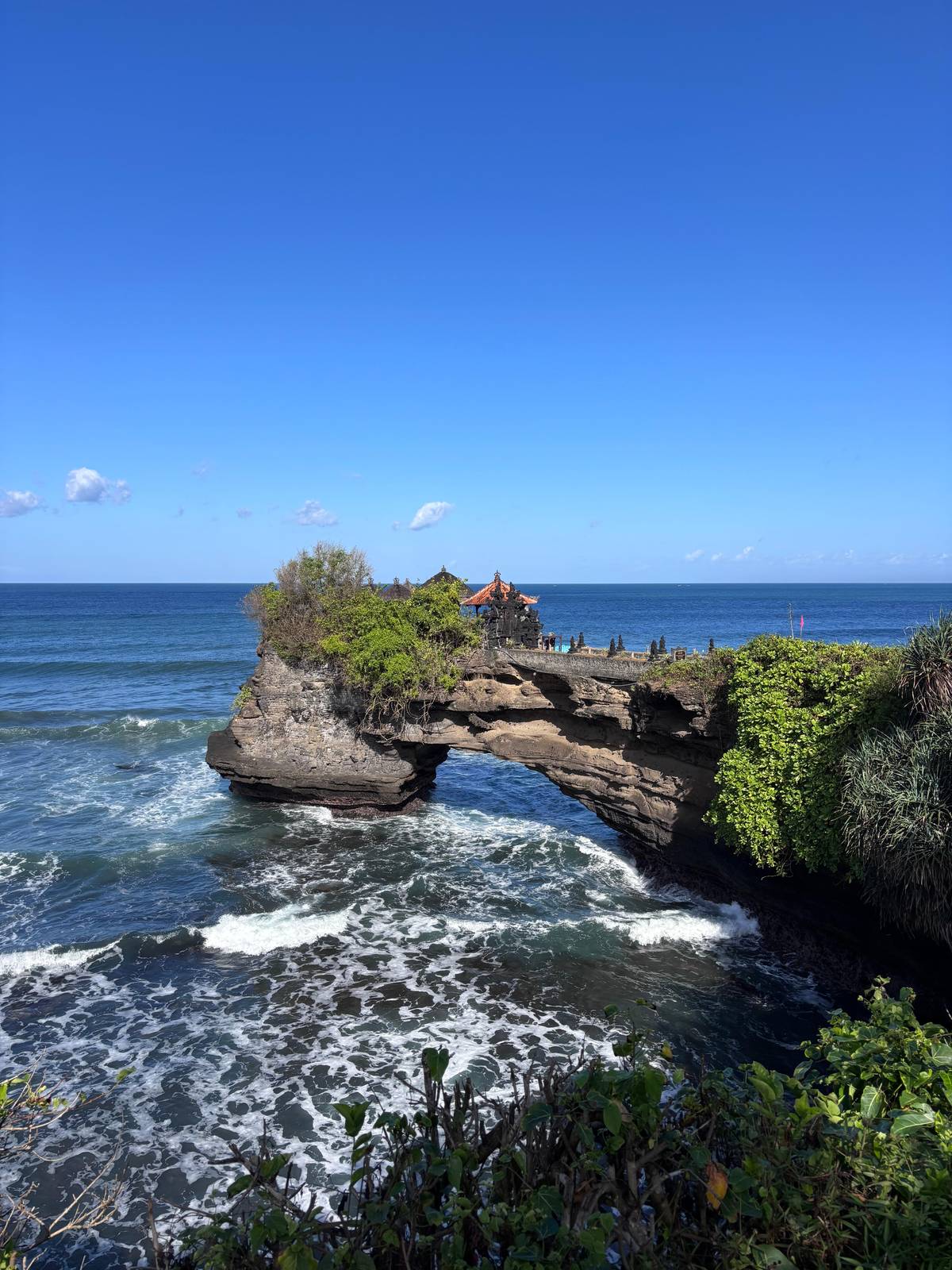 Pura Batu Bolong on its rock bridge over the waves