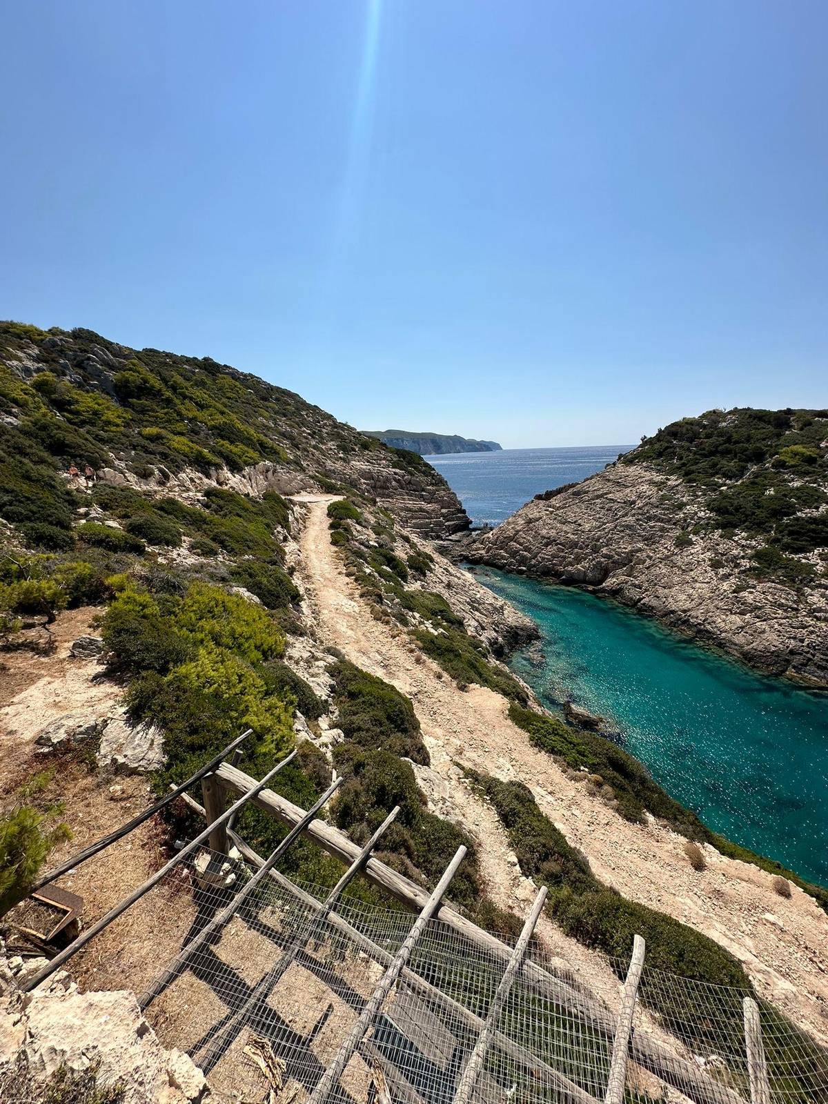 A dirt track winding down to a cove