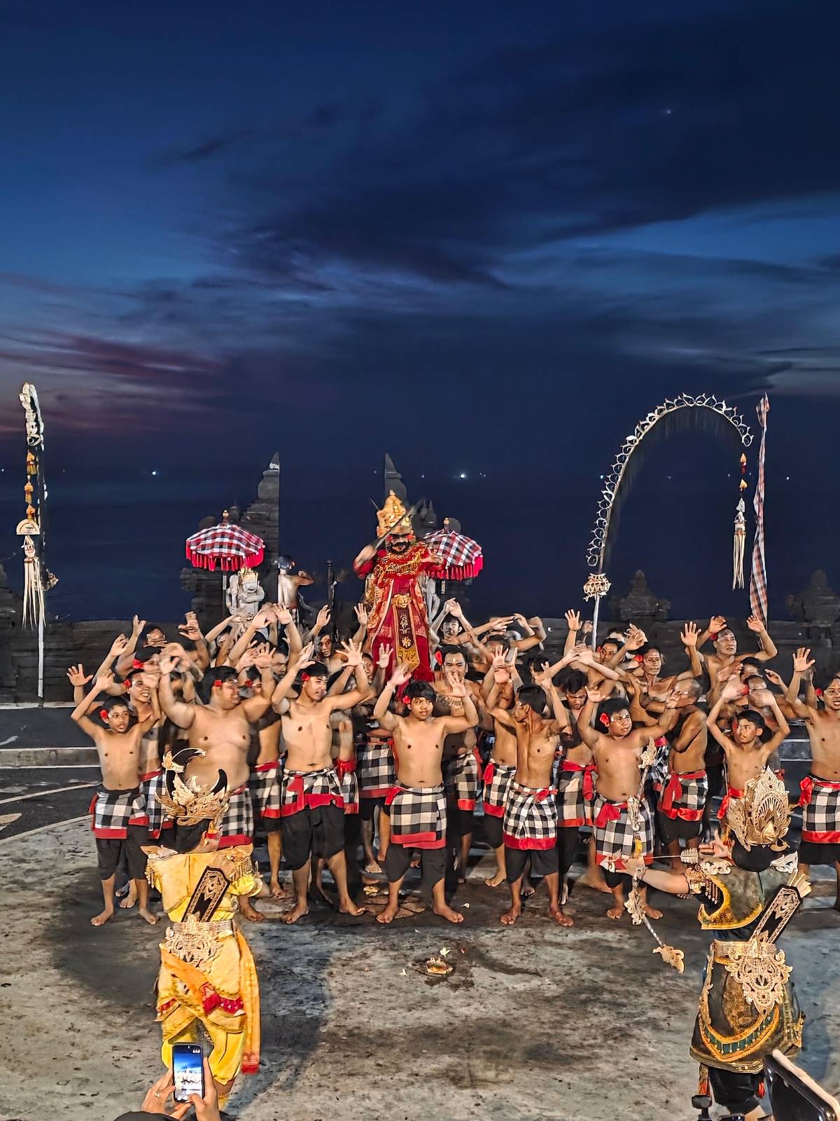 The chorus throws up its arms around the dancers at dusk