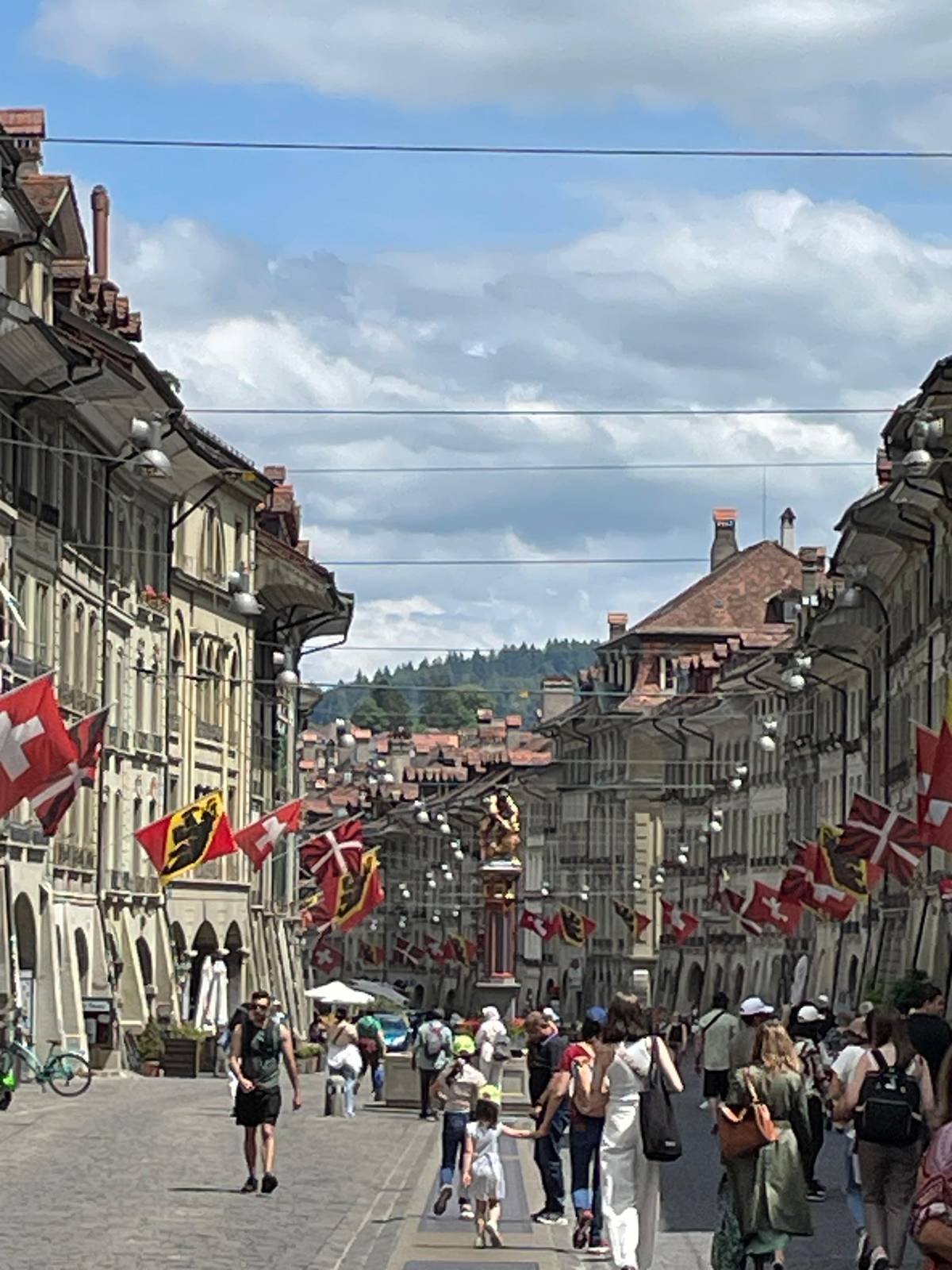 Flags over a busy arcaded street