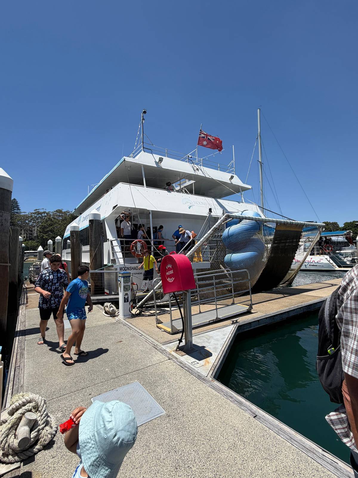 Guests walking along the wharf to board