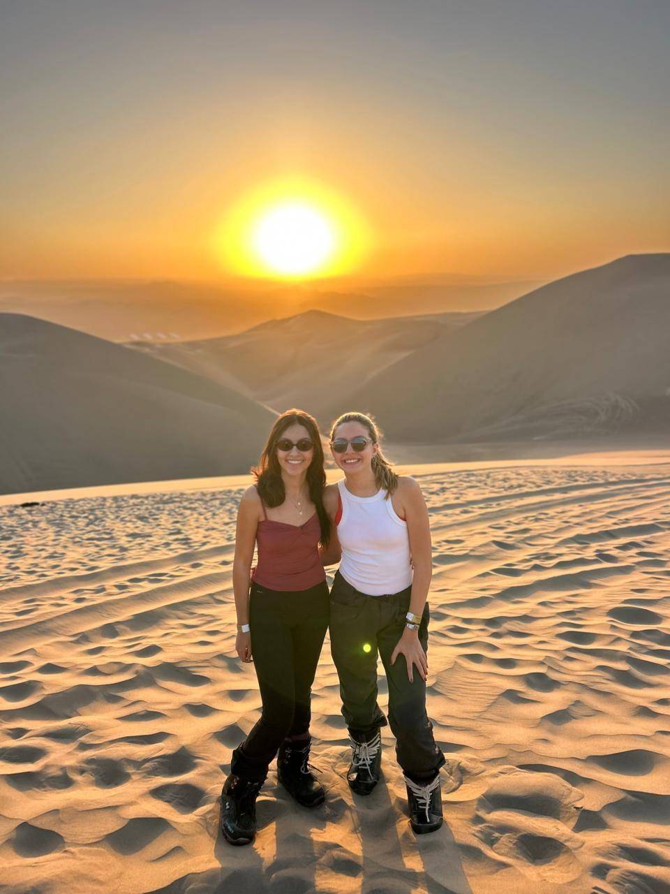 The sun low over a ridge of dunes