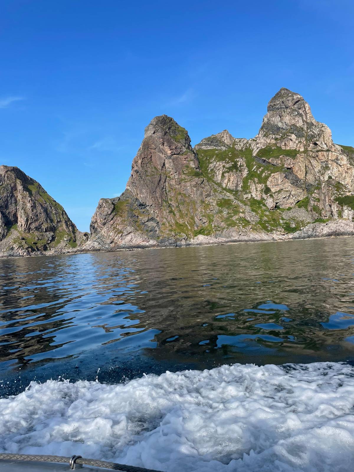 Steep peaks along the coast, seen from the boat