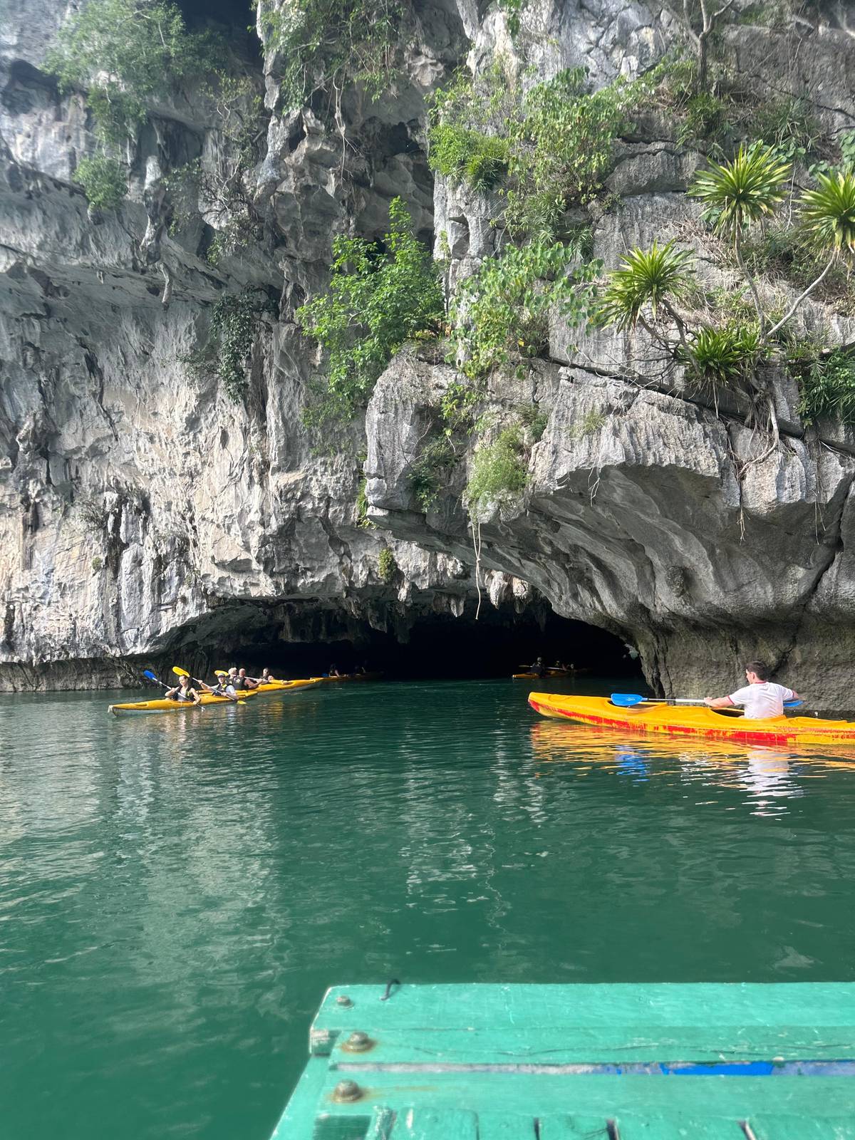 Kayaks gliding toward a cave mouth
