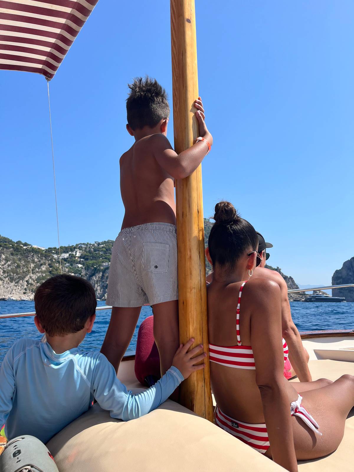 A family on the bow of a private boat