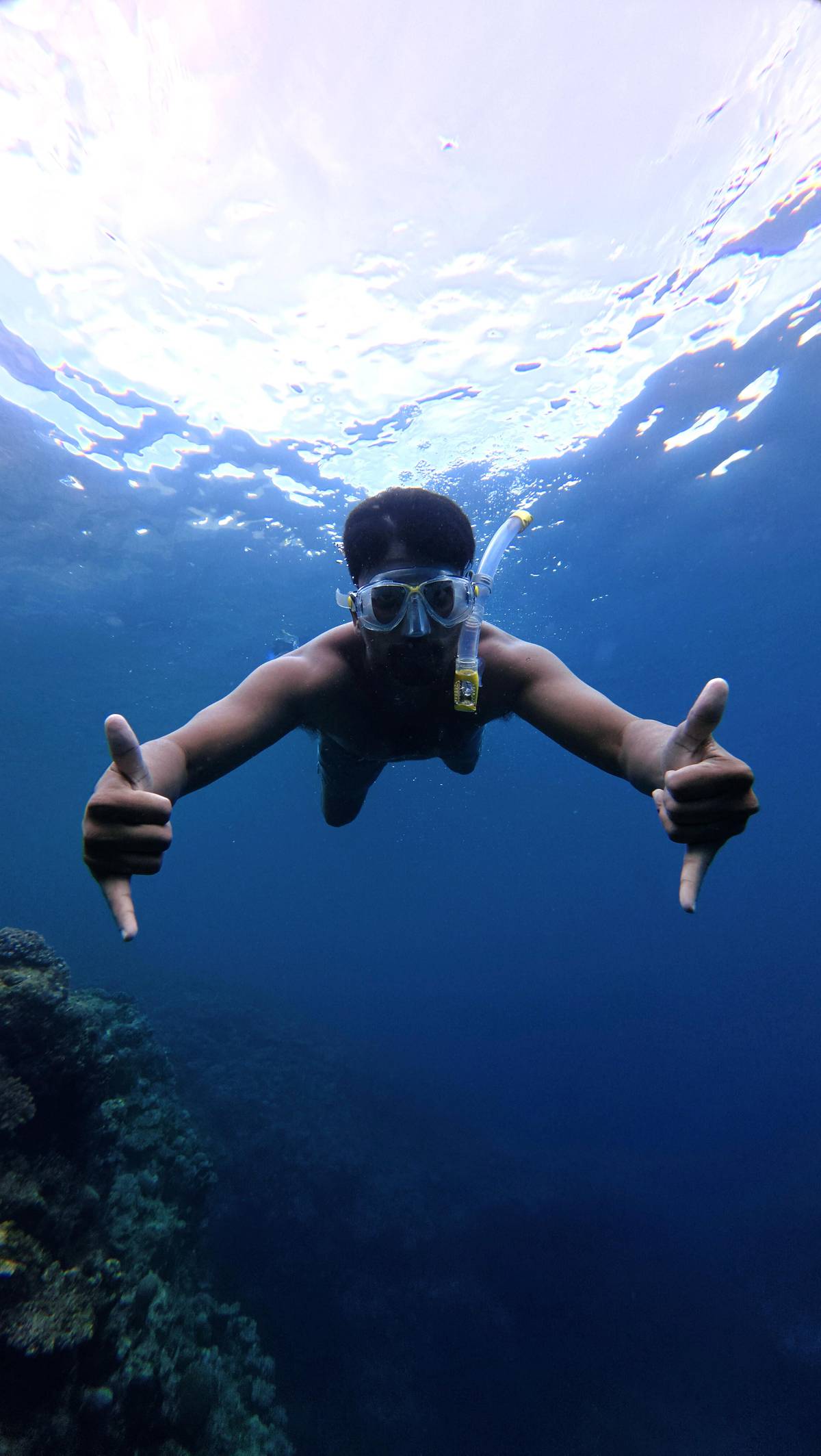 A snorkeler hanging in open water