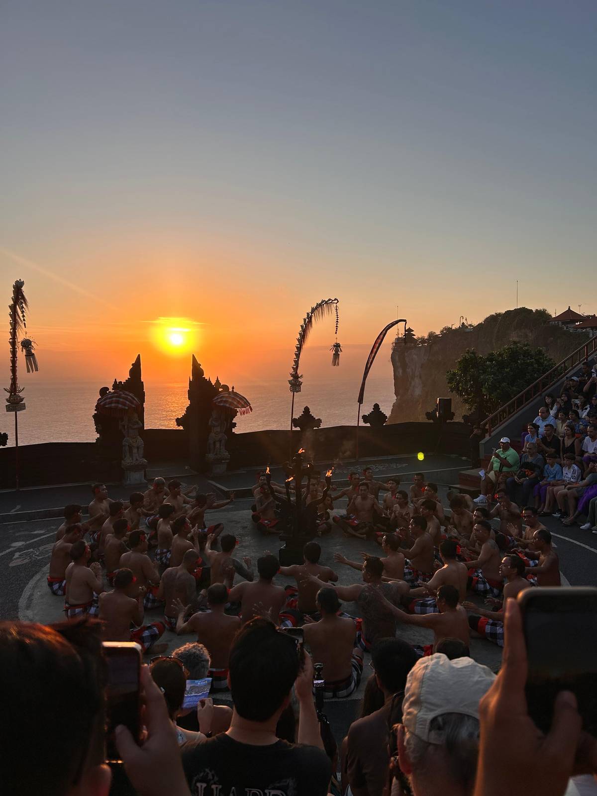 The sun sinking behind the split gate of the stage