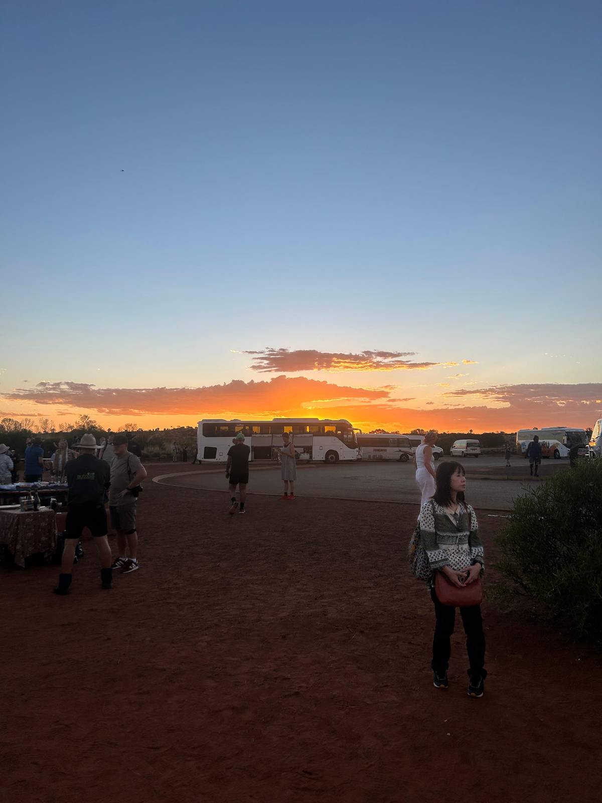 The sun going down over the coaches in the viewing area