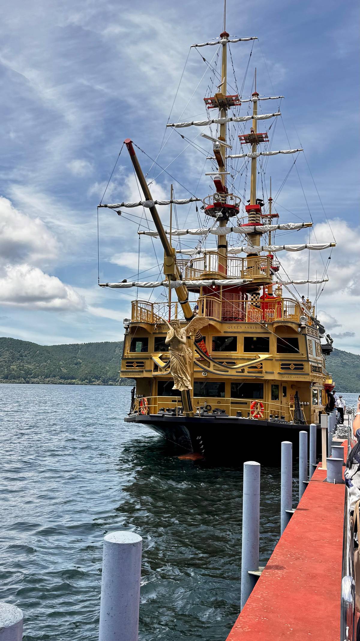 A gold-trimmed pirate ship moored at a pier
